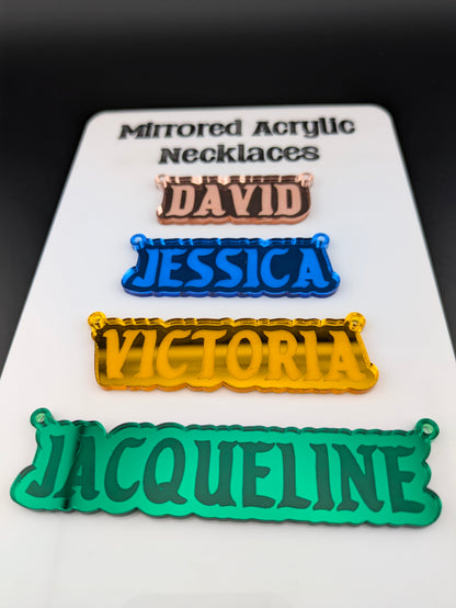 pink, blue, gold, and green custom named acrylic necklase pendants made out of mirrored acrylic.