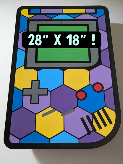 retro portable gaming device with colorable mosaic pattern painted on it. colors include purple, blue, and yellow. it is intended to be put on the wall as decor.