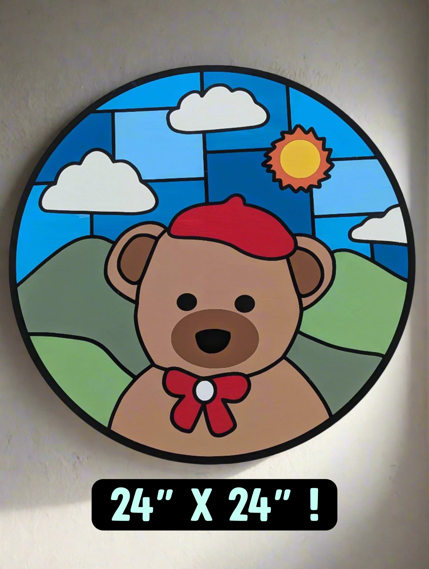 Wood wall art that shows a bear with a red hat and a blue sky and sun.